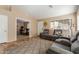 Living area featuring an open layout, tile flooring, and neutral walls provides a versatile space for relaxation and gatherings at 6430 E Riverdale St, Mesa, AZ 85215