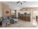 Bright living room with vaulted ceiling seamlessly connected to kitchen, creating an open concept design for modern living at 6430 E Riverdale St, Mesa, AZ 85215
