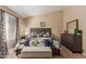 Comfortable main bedroom featuring a cozy bed, dresser, and a serene atmosphere for relaxation at 6430 E Riverdale St, Mesa, AZ 85215