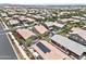 An aerial view shows a neighborhood with well-maintained homes, manicured landscaping, and community amenities at 7440 E Osage Ave, Mesa, AZ 85212