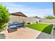 Inviting backyard features paved patio, artificial turf, landscaping, and a comfortable outdoor seating area at 7440 E Osage Ave, Mesa, AZ 85212