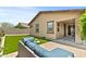 Well-kept backyard featuring artificial turf, patio with seating, landscaping, and a comfortable outdoor space at 7440 E Osage Ave, Mesa, AZ 85212