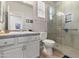 Bright bathroom with a double sink vanity, a glass-enclosed shower, and contemporary fixtures and finishes at 7440 E Osage Ave, Mesa, AZ 85212