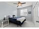 Comfortable bedroom with a ceiling fan and neutral paint, bathed in soft natural light at 7440 E Osage Ave, Mesa, AZ 85212