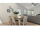 Bright dining area next to the Gathering room, showcasing stylish furniture and large windows for natural lighting at 7440 E Osage Ave, Mesa, AZ 85212