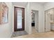 Inviting foyer featuring neutral paint, tiled floors, a decorative front door, and an open view into the house at 7440 E Osage Ave, Mesa, AZ 85212