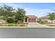 Charming single-story house with a green lawn, mature trees, and vibrant flower beds in a suburban neighborhood at 7440 E Osage Ave, Mesa, AZ 85212