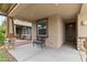 Inviting front porch featuring stone pillars, a cozy bench, and a view of the manicured front yard at 7440 E Osage Ave, Mesa, AZ 85212