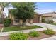 Charming home boasts a well-kept front yard with colorful flowers, mature trees and a two car garage at 7440 E Osage Ave, Mesa, AZ 85212