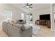 Cozy living room with natural light, a ceiling fan, and access to the outdoor patio at 7440 E Osage Ave, Mesa, AZ 85212