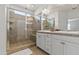 Bright main bathroom with dual sinks and a glass-enclosed tiled shower at 7440 E Osage Ave, Mesa, AZ 85212
