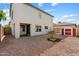 Exterior shot of a home's backyard with shed, covered patio, and neutral rock landscaping at 7500 E Deer Valley Rd # 54, Scottsdale, AZ 85255