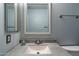 Bathroom vanity area featuring granite countertop, light blue walls, and framed mirror at 7500 E Deer Valley Rd # 54, Scottsdale, AZ 85255