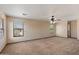 Spacious bedroom featuring neutral carpeting, ceiling fan, and natural light from several windows at 7500 E Deer Valley Rd # 54, Scottsdale, AZ 85255