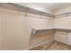 Walk-in closet featuring built in shelving and neutral carpeting at 7500 E Deer Valley Rd # 54, Scottsdale, AZ 85255