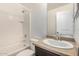 All-white bathroom featuring a shower-tub combination and a vanity with modern fixtures at 7732 W Bonitos Dr, Phoenix, AZ 85035