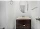 Clean half bath featuring a modern sink with stylish vanity and an oval mirror at 7732 W Bonitos Dr, Phoenix, AZ 85035