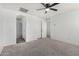 Bright bedroom with ceiling fan, two windows, and ensuite bathroom access is great for guests at 7732 W Bonitos Dr, Phoenix, AZ 85035