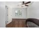 Bright bedroom with hardwood floors, neutral paint, ceiling fan, and sunny windows at 7732 W Bonitos Dr, Phoenix, AZ 85035