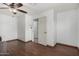Bedroom boasts gleaming hardwood floors, ceiling fan, and easy access to the ensuite bathroom at 7732 W Bonitos Dr, Phoenix, AZ 85035