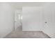 Bright bedroom with neutral carpet and light walls, perfect as a guest bedroom or hobby room at 7732 W Bonitos Dr, Phoenix, AZ 85035