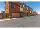 Street view of townhomes with attached garages and well-maintained landscaping at 7732 W Bonitos Dr, Phoenix, AZ 85035