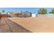 Large backyard featuring a covered patio, storage shed, block fence and potential for landscaping and customization at 7849 E Golf Ave, Mesa, AZ 85209