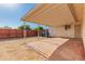 Spacious backyard with a covered patio, brick paving, and a mix of open space and fencing at 7849 E Golf Ave, Mesa, AZ 85209