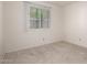 Bright bedroom featuring neutral carpet and a window with vertical blinds letting in natural light at 7849 E Golf Ave, Mesa, AZ 85209