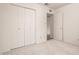 This bedroom features a large closet with multiple doors and neutral carpeting throughout at 7849 E Golf Ave, Mesa, AZ 85209