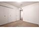 Bedroom with carpet flooring, closet, and an adjacent doorway at 7849 E Golf Ave, Mesa, AZ 85209