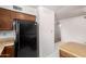 Kitchen area featuring matching black refrigerator and oven appliances and tile flooring at 7849 E Golf Ave, Mesa, AZ 85209