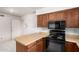 Kitchen area with a view of a black oven and a light wood countertop and cabinets at 7849 E Golf Ave, Mesa, AZ 85209