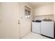 Functional laundry room with a washer, dryer, and a window for natural light at 7849 E Golf Ave, Mesa, AZ 85209