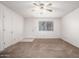 Cozy living room with neutral carpet, a ceiling fan, and a view of the front yard at 7849 E Golf Ave, Mesa, AZ 85209