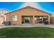 Inviting backyard featuring a well-manicured lawn, covered patio, and barbecue area at 8209 S 23Rd Pl, Phoenix, AZ 85042