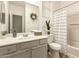 Bright bathroom with coordinated design, includes a vanity, toilet, and shower-tub combination at 8209 S 23Rd Pl, Phoenix, AZ 85042