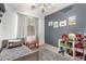 Cozy bedroom with natural light, neutral color walls, and a ceiling fan at 8209 S 23Rd Pl, Phoenix, AZ 85042