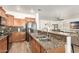 Open kitchen featuring granite countertops, stainless appliances, and a breakfast bar at 8209 S 23Rd Pl, Phoenix, AZ 85042