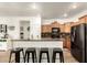 Modern kitchen with a granite counter breakfast bar and stainless steel appliances at 8209 S 23Rd Pl, Phoenix, AZ 85042
