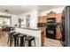 Open kitchen with breakfast bar, granite countertops, and stainless steel appliances at 8209 S 23Rd Pl, Phoenix, AZ 85042