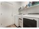 Functional laundry room with modern appliances and built-in shelving at 8209 S 23Rd Pl, Phoenix, AZ 85042