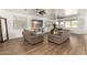 Expansive living room with wood floors, ceiling fans, and plenty of natural light at 8209 S 23Rd Pl, Phoenix, AZ 85042