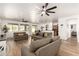 Bright, open-concept living area with wood floors and views to the kitchen and dining areas at 8209 S 23Rd Pl, Phoenix, AZ 85042
