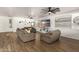 Comfortable living area featuring wood floors, neutral walls, and a ceiling fan at 8209 S 23Rd Pl, Phoenix, AZ 85042