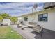 Outdoor living space featuring patio with seating, grill, and manicured lawn at 8320 E Monte Vista Rd, Scottsdale, AZ 85257
