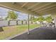 Spacious backyard featuring a covered patio, lush green lawn, and privacy wall at 8320 E Monte Vista Rd, Scottsdale, AZ 85257