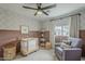 This charming Bedroom features soft colors, a cozy chair, and a comfortable space for a little one at 8320 E Monte Vista Rd, Scottsdale, AZ 85257