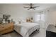 This bright bedroom offers neutral decor, a ceiling fan, and plenty of natural light from the window at 8320 E Monte Vista Rd, Scottsdale, AZ 85257
