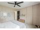 Charming bedroom features paneled walls, a ceiling fan, and an en-suite door at 8320 E Monte Vista Rd, Scottsdale, AZ 85257